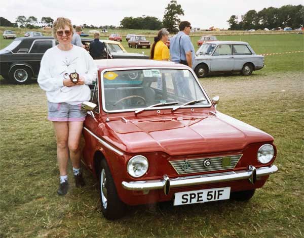 Pleased owner with trophy standing by Singer Chamois Coupe